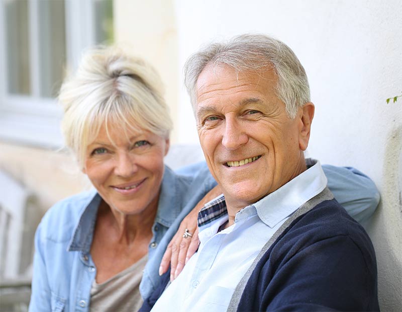 Happy older couple sitting on a porch